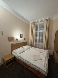 a bedroom with a bed and a window at Penzion Dubík in Dubí +10 photos