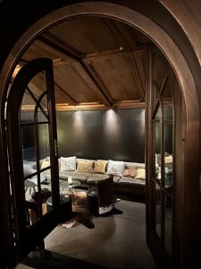 a living room with a couch and a mirror at Marmotta Alpin hotel in Mühlbach am Hochkönig