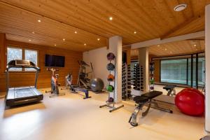 a gym with several treadmills and machines in a room at Chalet le 4 - Numéro 2 in Le Grand-Bornand