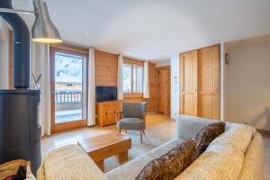a living room with a couch and a table at Chalet le 4 - Numéro 2 in Le Grand-Bornand +20 photos