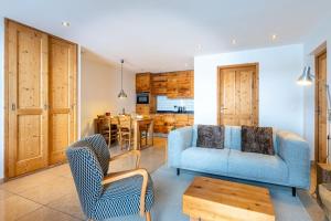 a living room with a couch and chairs and a table at Chalet le 4 - Numéro 2 in Le Grand-Bornand