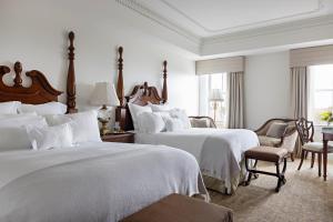 a hotel room with two beds with white sheets at Market Pavilion Hotel in Charleston