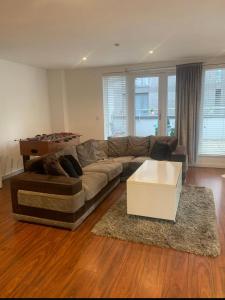a living room with a couch and a coffee table at Spacious Central Penthouse Apartment With Parking in Manchester