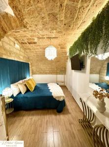 a bedroom with a bed with a blue comforter at L'Antica Dimora Deluxe in Bari