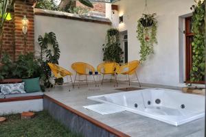 a bath tub sitting on a patio with chairs at Senora Ines Hotel Boutique in Buga