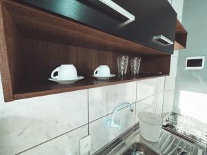 a kitchen with a sink and a counter at Pousada AMD in Florianópolis