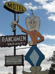 a sign for a motel with a monkey on it at Ranchmen Motel in Medicine Hat