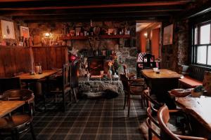 a restaurant with tables and chairs and a fireplace at Stein Inn in Stein