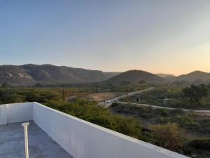 a view of the mountains from the balcony of a house at Riya Home Stay in Sawāi Mādhopur