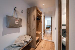 a room with a closet and a bag on the wall at Krahof Dolomites - Urlaub auf dem Bauernhof in Castelrotto +96 photos