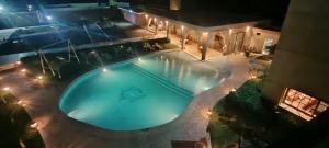 an overhead view of a swimming pool at night at club suite de luxe a avec piscine in Oulad Teïma