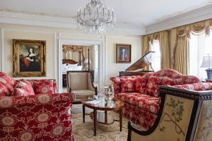 a living room with red furniture and a chandelier at Market Pavilion Hotel in Charleston
