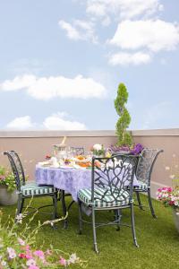 a table and chairs on a patio with flowers at Market Pavilion Hotel in Charleston