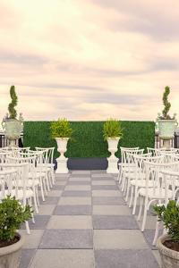 a set up for a wedding ceremony with white chairs at Market Pavilion Hotel in Charleston