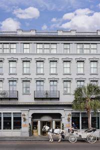 a horse drawn carriage in front of a building at Market Pavilion Hotel in Charleston