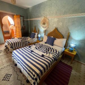 A bed or beds in a room at Riad Jenan Adam