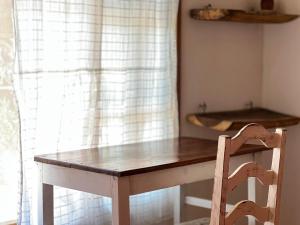 a wooden table and a chair in front of a window at Casa Azar in Mazunte +67 photos