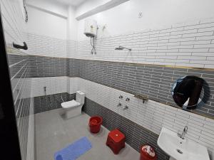 a bathroom with a sink and a toilet at Kharari Inn in Ayodhya
