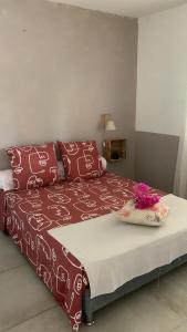 a bedroom with a large bed with red pillows at La Perle Bleue, ,Condo 1 chambre bord de mer et piscine ,Trois ilets in Les Trois-Îlets +20 photos