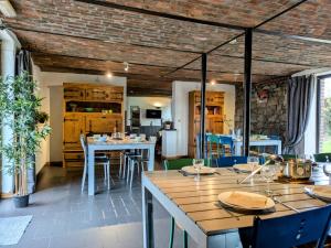a dining room with wooden tables and chairs at La Ferme Du Pré Charmant in Durbuy