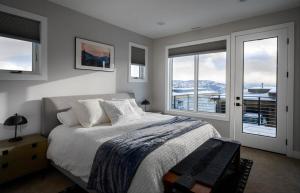 a bedroom with a bed with a view of a boat at Million-Dollar Views, Luxury Stay Near Park City in Keetley