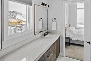 a bathroom with a sink and a mirror and a bed at Million-Dollar Views, Luxury Stay Near Park City in Keetley +50 photos