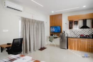a kitchen with a refrigerator and a table in it at Bigson Blissful Studios in Hyderabad