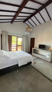 a bedroom with a large bed in a room at Casa Vivienda - Barra Grande in Barra Grande