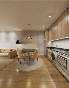 a kitchen and living room with a table and chairs at Apartamentos Ovetum in Oviedo +5 photos