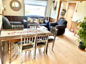 a living room with a wooden table and chairs at Casa Vintage Puerto Varas in Puerto Varas