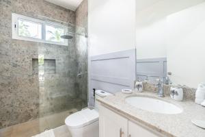 a bathroom with a toilet and a sink and a shower at Casa Blue Monkey - Playa Conchal in Brasilito +15 photos