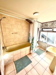 une salle de bain avec une baignoire verte et un lavabo dans l'établissement Casa Vintage Puerto Varas, à Puerto Varas