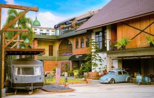an old car parked in front of a building at Dream Factory Hotel in Udon Thani
