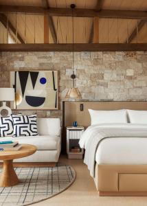 a bedroom with a bed and a couch at One&Only Aesthesis, Athens in Athens +37 photos
