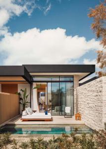 a house with a pool and a bed in it at One&Only Aesthesis, Athens in Athens