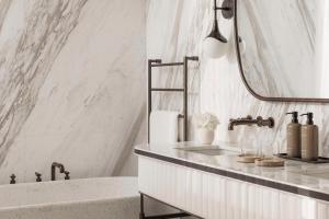 a bathroom with a sink and a mirror and a tub at One&Only Aesthesis, Athens in Athens