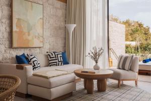 a living room with a couch and a table at One&Only Aesthesis, Athens in Athens