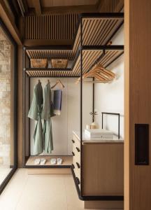 a walk in closet with a dresser and shoes at One&Only Aesthesis, Athens in Athens