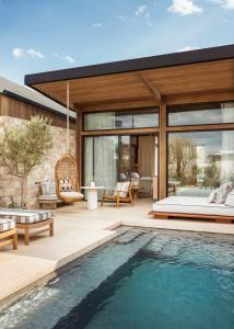 a villa with a swimming pool and a house at One&Only Aesthesis, Athens in Athens