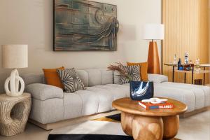 a living room with a couch and a table at One&Only Aesthesis, Athens in Athens