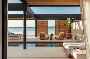 a living room with a view of the ocean at One&Only Aesthesis, Athens in Athens