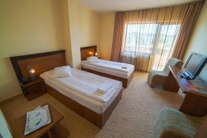 En eller flere senge i et værelse på Hotel Restaurant Corsa