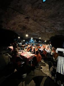 a group of people sitting at tables in a room at Hotel Casino San Eugenio del Cuareim in Artigas