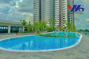 a large blue swimming pool in front of a building at Arena Designer Suite 3BR KLIA in Sepang