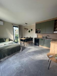 a bedroom with a bed and a kitchen with a table at Natura Home in Skoki +15 photos