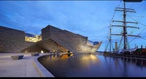two large buildings next to a body of water at Toasty & Warm Beds in Dundee