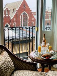 a table with a tray of food and orange juice on a balcony at Market Pavilion Hotel in Charleston