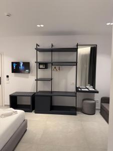 a room with a bed and a desk in it at Adele Hotel Ksamil in Ksamil