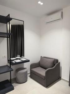 a living room with a chair and a mirror at Adele Hotel Ksamil in Ksamil