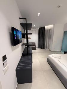 a room with a bed and a tv on a wall at Adele Hotel Ksamil in Ksamil